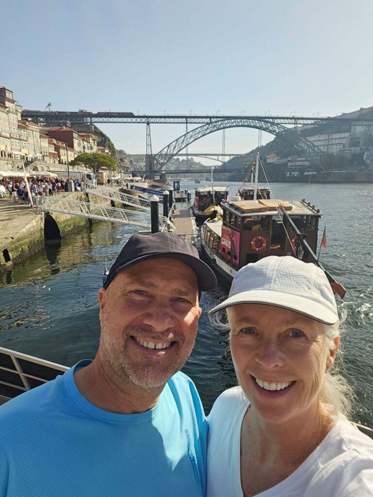 a couple taking a picture in Porto, a Portugal resort town with a fam