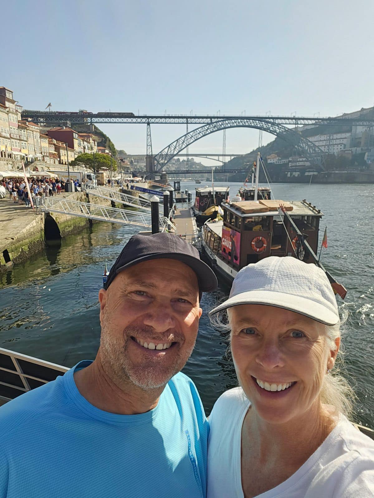 a couple taking a picture in Porto, a Portugal resort town with a fam