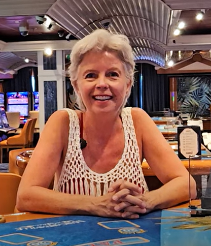 a smiling woman at a casino black jack table